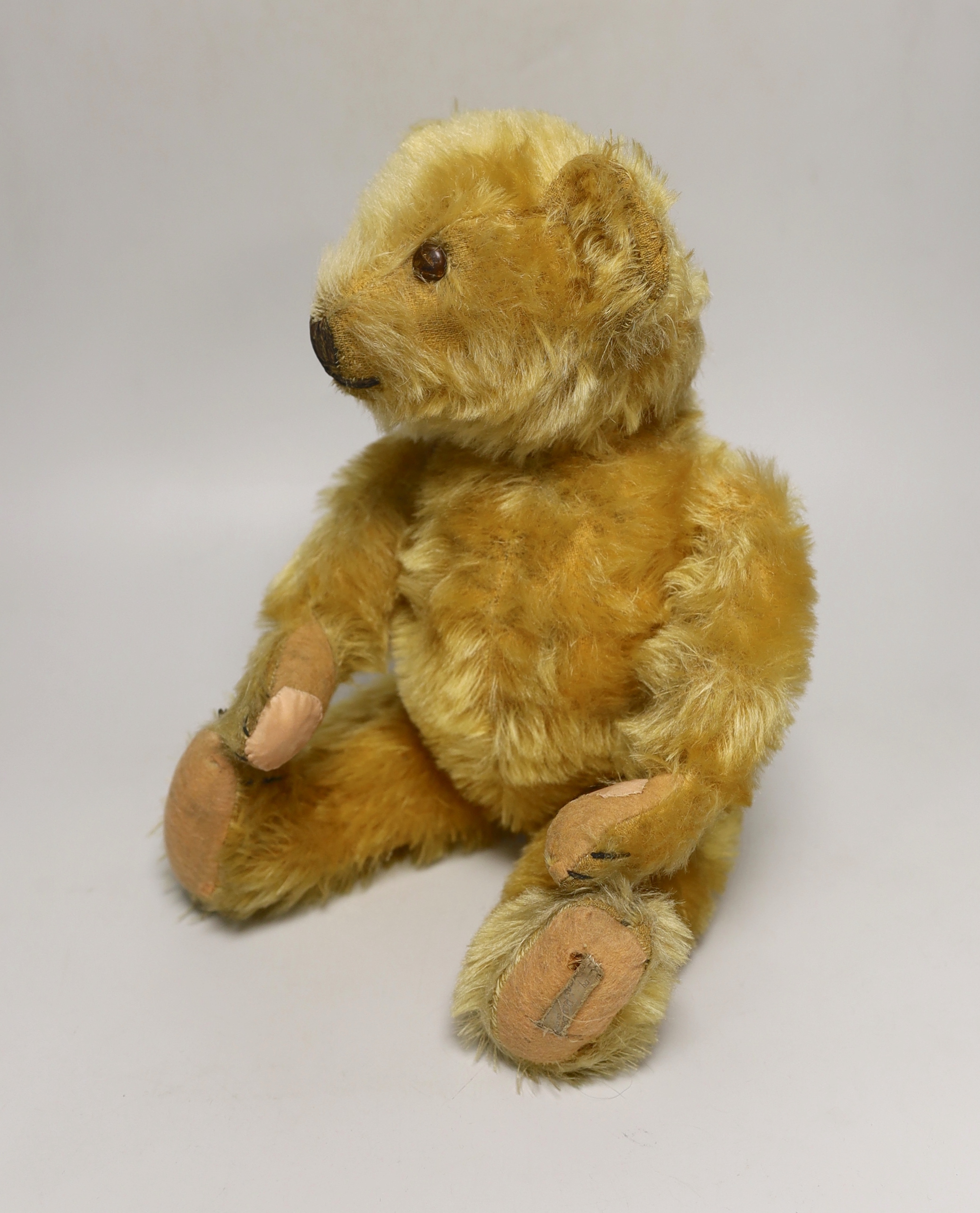 A Deans 1950's mouse eared bear, label on left foot, 16in., repair to paw pads, good mohair